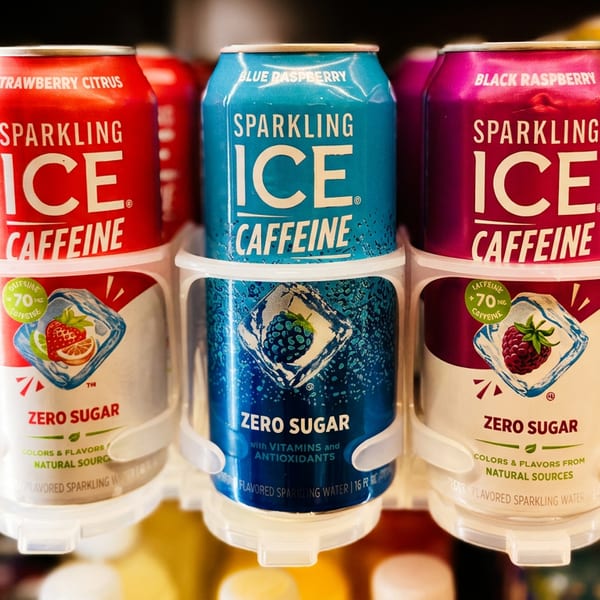 Sparkling Ice Caffeine drinks in strawberry citrus, blue raspberry, and black raspberry flavors in a cooler.